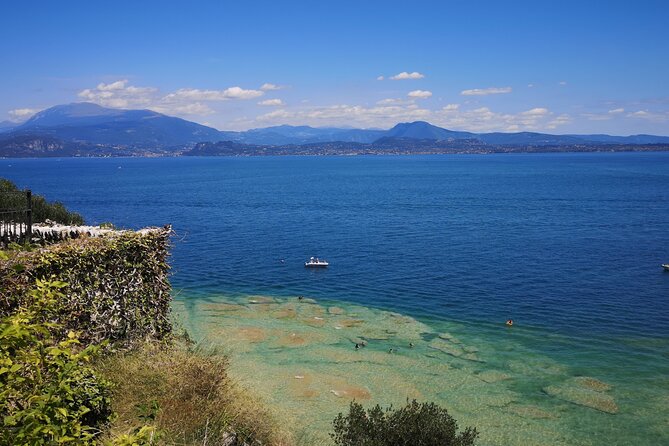 Sirmione away from the Crowds Boat Cruise Guided Walk and a Drink - Spiaggia Lido delle Bionde and Monte Baldo framing